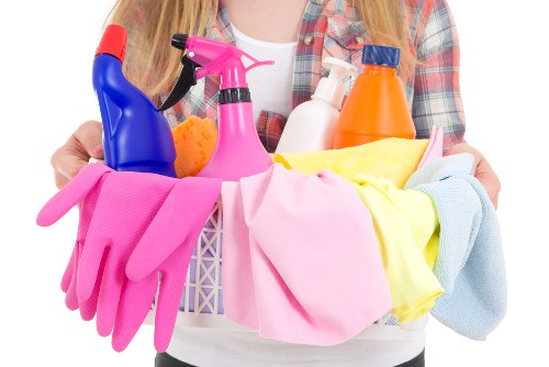 Cleaner preparing a kitchen and bathroom clean in a Merton flat