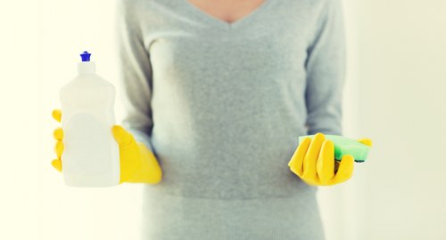 Deep cleaning a living room sofa in a Merton property