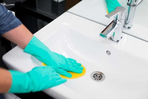 Local technician treating stains on a sofa upholstery