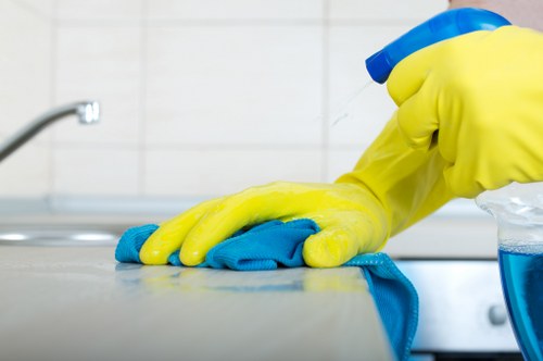 Cleaner vacuuming a commercial office corridor in Merton