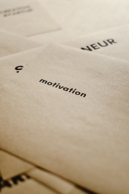 Close-up image of layered printed pages featuring text in black ink. The visible words include 'VEUR' and 'motivation,' with a focus on the smooth, matte surface of the paper that appears clean and free of smudges. The pages are slightly curled and stacked, showcasing a minimalistic layout with a close-up perspective. The soft lighting highlights the texture of the paper, emphasizing its quality, while the overall scene conveys a sense of organization and clarity suitable for activities such as surface cleaning or document maintenance, as part of comprehensive hygiene or deep cleaning services by Deep Cleaning Merton, a professional cleaning company in Merton.